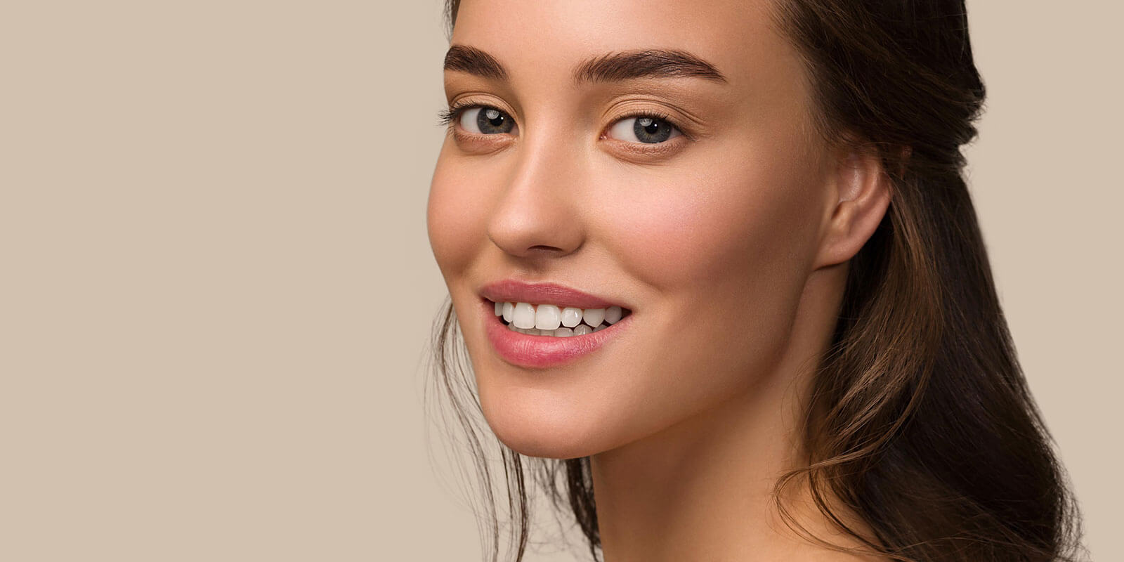 Woman smiling at camera to show teeth whitening